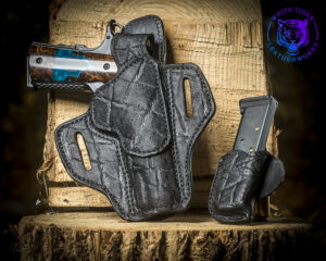 1911 thumb break holster in genuine black elephant, with a matching mag pouch.